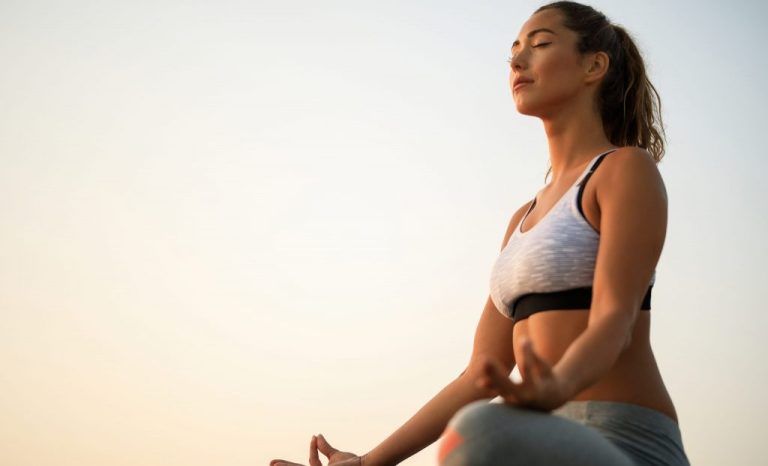 vista-de-angulo-baixo-da-mulher-com-os-olhos-fechados-praticando-yoga-contra-o-ceu-copie-o-espaco-scaled-e1760123512716-1024x621
