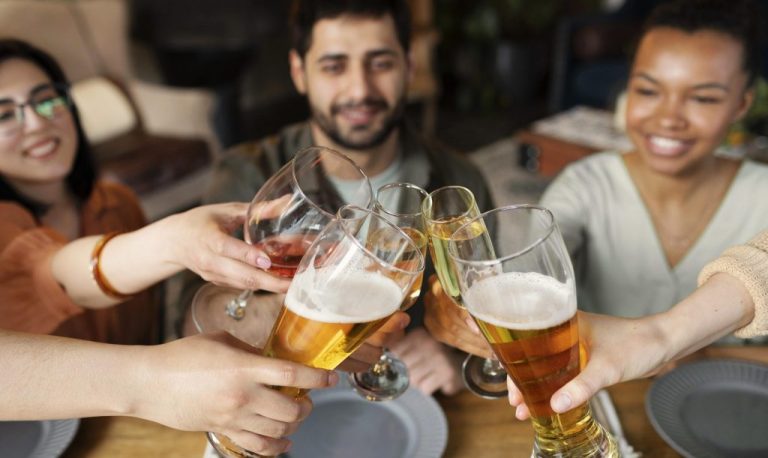 close-up-friends-clinking-glasses-scaled-e1765905288113-1024x611