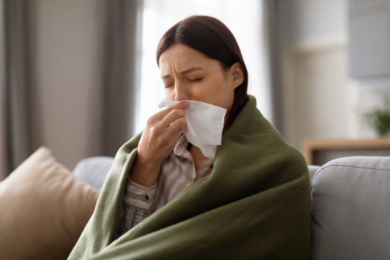 sick-young-woman-wrapped-blanket-blowing-her-nose-1024x683-1